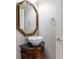 Stylish powder room with furniture-style vanity and decorative mirror at 612 Champions Dr, Mcdonough, GA 30253