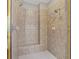 Walk in shower featuring tile surround, built in bench, and dual shower heads at 612 Champions Dr, Mcdonough, GA 30253