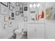 Unique half bathroom adorned with a quirky gallery wall and modern fixtures at 120 Vanira Se Ave, Atlanta, GA 30315
