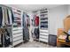 Walk-in closet with custom shelving and ample storage for clothing, shoes, and accessories at 120 Vanira Se Ave, Atlanta, GA 30315