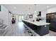 Modern kitchen with white countertops, black cabinets, and a large island with seating at 120 Vanira Se Ave, Atlanta, GA 30315