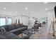 Open-concept living area that showcases a gray sofa, modern kitchen and dining area at 120 Vanira Se Ave, Atlanta, GA 30315