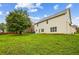 Expansive backyard featuring lush green lawn, mature trees, and a charming two-story home at 1212 Ashton Park Dr, Lawrenceville, GA 30045