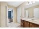 Bathroom featuring tile flooring, a wood vanity, a sink, and a doorway into the next room at 1212 Ashton Park Dr, Lawrenceville, GA 30045