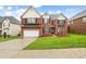 Beautiful two-story brick home with a manicured lawn and attached two car garage at 1212 Ashton Park Dr, Lawrenceville, GA 30045