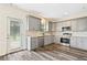 Well-lit kitchen with gray cabinets, stainless appliances, and door to the outside at 1212 Ashton Park Dr, Lawrenceville, GA 30045
