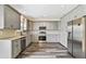 Modern kitchen featuring updated cabinets, stainless steel appliances, and a stylish subway tile backsplash at 1212 Ashton Park Dr, Lawrenceville, GA 30045