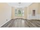 Cozy living room featuring gray wood flooring, large bay windows, and neutral paint at 1212 Ashton Park Dr, Lawrenceville, GA 30045
