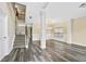 Bright living room with gray wood flooring, crown molding, and a staircase to the second level at 1212 Ashton Park Dr, Lawrenceville, GA 30045
