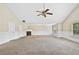Expansive living room with crown molding, carpet flooring, and a cozy fireplace at 1212 Ashton Park Dr, Lawrenceville, GA 30045