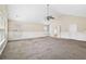 Bright living room featuring neutral tones, carpet flooring, and multiple windows at 1212 Ashton Park Dr, Lawrenceville, GA 30045