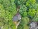 A serene aerial view of a home with a deck and lush trees, offering a private and green landscape at 1625 Clark Lake Nw Dr, Acworth, GA 30102