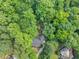 A bird's-eye view of a charming house nestled amidst a lush forest and a long driveway at 1625 Clark Lake Nw Dr, Acworth, GA 30102