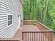 A spacious wooden back deck with brown railings offers a private outdoor retreat next to wooded area at 1625 Clark Lake Nw Dr, Acworth, GA 30102
