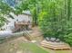 Large backyard view showcasing the elevated deck with seating and the expansive forested landscape at 1625 Clark Lake Nw Dr, Acworth, GA 30102