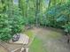 Large backyard features a wooden deck with outdoor seating, a playground and a wood fence at 1625 Clark Lake Nw Dr, Acworth, GA 30102