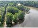 Aerial view of the community lake featuring mature trees and clear skies at 1625 Clark Lake Nw Dr, Acworth, GA 30102