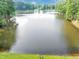 Expansive view of the community lake with tree-lined shores and calm waters at 1625 Clark Lake Nw Dr, Acworth, GA 30102