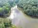 Scenic aerial shot of a lake within a lush, green community, showcasing serene waters and trees at 1625 Clark Lake Nw Dr, Acworth, GA 30102