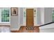 A welcoming entryway with hardwood floors, sidelight windows, a wooden door, and a decorative black and white mat at 1625 Clark Lake Nw Dr, Acworth, GA 30102