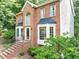 A two-story red brick house with black trim and manicured landscaping at 1625 Clark Lake Nw Dr, Acworth, GA 30102