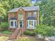 Traditional brick home with arched window, bay windows and mature landscaping with manicured lawn at 1625 Clark Lake Nw Dr, Acworth, GA 30102