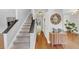 Hallway with staircase and light wood floors with a console table and mirror at 1625 Clark Lake Nw Dr, Acworth, GA 30102