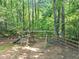 A fun playground with a wooden playset, swings, and slide, nestled in a shady, fenced yard at 1625 Clark Lake Nw Dr, Acworth, GA 30102