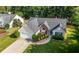 Aerial view of a well-maintained house, landscaped yard, and neighborhood at 3313 Harmon Ridge Ct, Buford, GA 30519