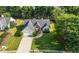 Aerial view of a beautifully landscaped home with a well-maintained lawn and mature trees in a quiet neighborhood at 3313 Harmon Ridge Ct, Buford, GA 30519