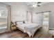 Bright bedroom with a vaulted ceiling, wood floors, and a sliding barn door to an en-suite bath at 3313 Harmon Ridge Ct, Buford, GA 30519