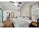 Bright bedroom with a vaulted ceiling, modern decor, wood floors, and a sliding barn door to an en-suite bath and closet at 3313 Harmon Ridge Ct, Buford, GA 30519
