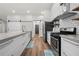 Modern kitchen with white cabinets, a subway tile backsplash, stainless steel appliances, and concrete countertops at 3313 Harmon Ridge Ct, Buford, GA 30519