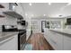 Bright kitchen with white cabinets, subway tile backsplash, stainless steel appliances, and a concrete countertop island at 3313 Harmon Ridge Ct, Buford, GA 30519