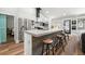 Modern kitchen island with seating, stainless steel appliances, and stylish lighting at 3313 Harmon Ridge Ct, Buford, GA 30519