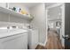 Convenient laundry room with modern appliances, ample storage shelves, and easy access to the kitchen at 3313 Harmon Ridge Ct, Buford, GA 30519