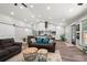 Bright living room featuring modern decor, vaulted ceiling, and seamless flow to the kitchen at 3313 Harmon Ridge Ct, Buford, GA 30519