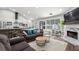 Open concept living room and kitchen with stainless steel appliances and a cozy fireplace at 3313 Harmon Ridge Ct, Buford, GA 30519