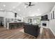 Open concept living space with kitchen island, fireplace, and wood floors offering a bright airy feel at 3313 Harmon Ridge Ct, Buford, GA 30519