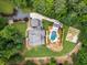 Overhead view of a house with a pool, garden, greenhouse, patio area, and landscaped lawn at 390 Hembree Rd, Roswell, GA 30075