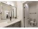 Modern bathroom showcasing a gray vanity, updated fixtures, and view to an adjacent exercise space at 390 Hembree Rd, Roswell, GA 30075