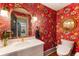 Stylish powder room with vibrant floral wallpaper, modern fixtures, and a marble countertop at 390 Hembree Rd, Roswell, GA 30075