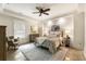 Comfortable bedroom featuring a bed, soft carpet, natural light, and neutral color palette at 390 Hembree Rd, Roswell, GA 30075