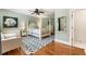 Comfortable bedroom with hardwood floors, a four-poster bed, and soft blue walls, offering a cozy retreat at 390 Hembree Rd, Roswell, GA 30075