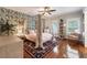 Cozy bedroom with a four-poster bed, palm wallpaper, hardwood floors, and bright windows, creating a serene retreat at 390 Hembree Rd, Roswell, GA 30075