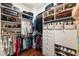 Organized walk-in closet with built-in shelving and drawers, showcasing ample storage for clothes, shoes and accessories at 390 Hembree Rd, Roswell, GA 30075