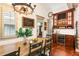 Dining room featuring a wooden table, built-in bar with a wine fridge, and hardwood floors at 390 Hembree Rd, Roswell, GA 30075