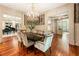 Elegant dining room with hardwood floors, chandelier, and seamless flow to other living areas at 390 Hembree Rd, Roswell, GA 30075