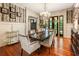 Elegant dining room with a crystal chandelier, wainscoting, and french doors at 390 Hembree Rd, Roswell, GA 30075