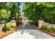 Gated driveway leading to estate home with manicured landscaping at 390 Hembree Rd, Roswell, GA 30075